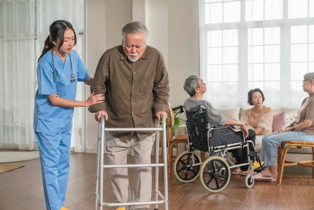 Asian caregiver assisting senior resident
